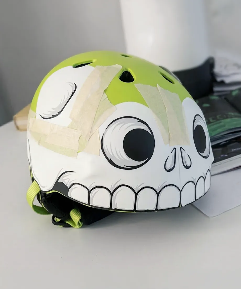 Hand-painted skull helmet prototype on a desk